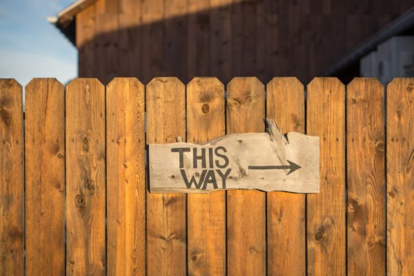 A sign with an arrow and the words This way